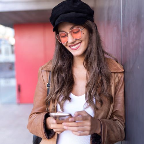 A young woman using phone in city